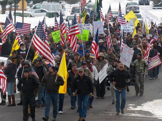 Protesters march on Court Avenue on Saturday, Jan. 2, 2016, in support of an Oregon ranching family facing jail time for arson in Burns, Ore. Family members were convicted of the arsons three years ago and served time. But a judge ruled their terms were too short under federal law and ordered them back to prison for about four years each.