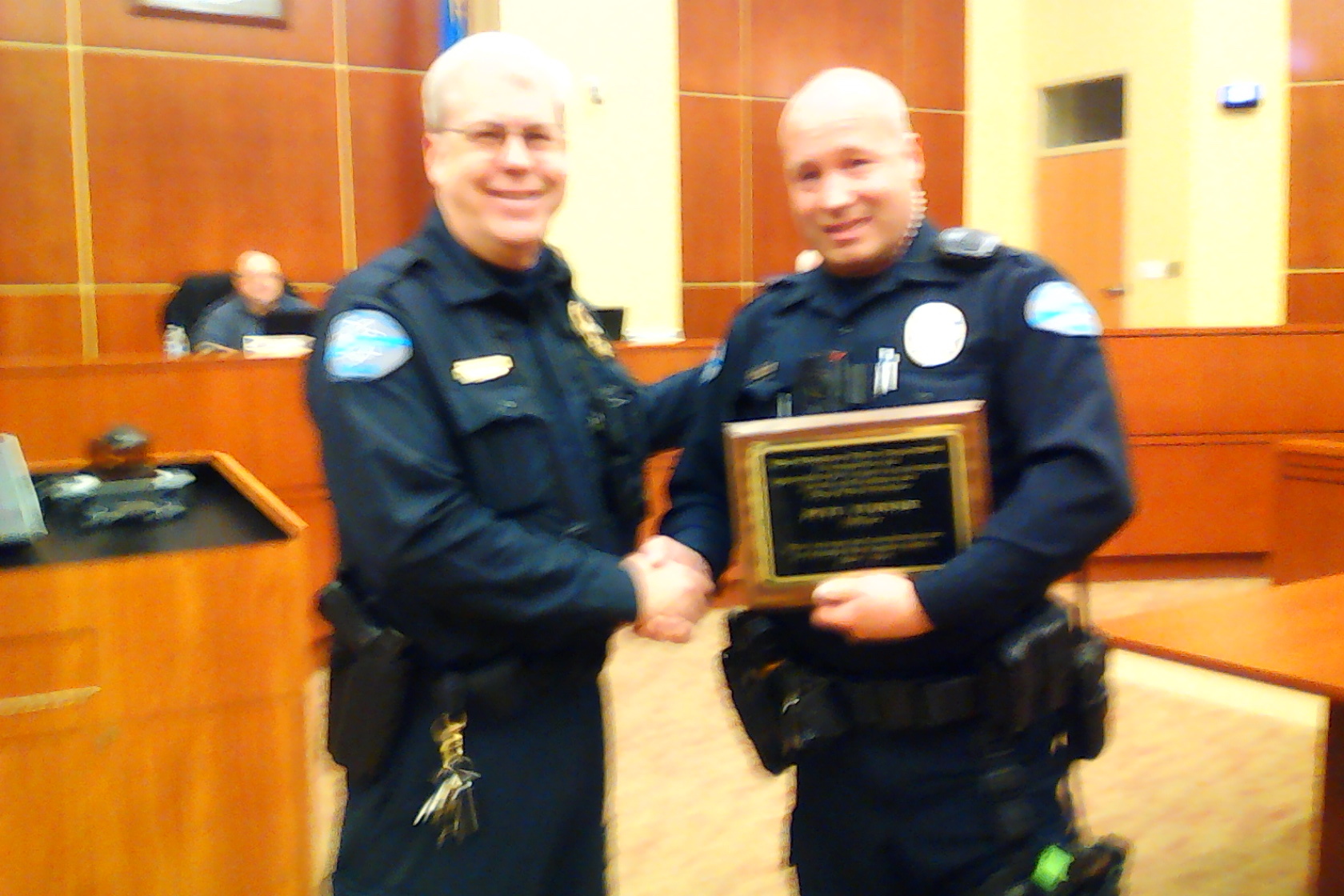 Police Officer Pete Turner receiving a recognition plaque for 10 Years of Service from Police Chief Burdel Welsh. 